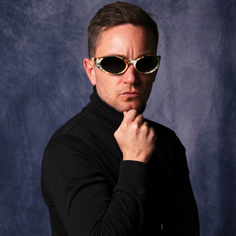 | photo_of_person_2.JPG | The Actualbush Slammer by Pit Viper, 1999 retro oval sunglasses with deerstalker camouflage on the frame