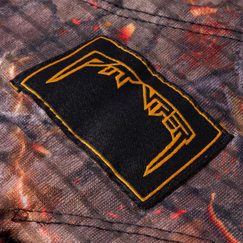 | im_ready_for_my_closeup.JPG | Close-up of a rectangular black patch with a yellow border and stylized yellow lettering, sewn onto camouflage fabric with red-orange flecks.