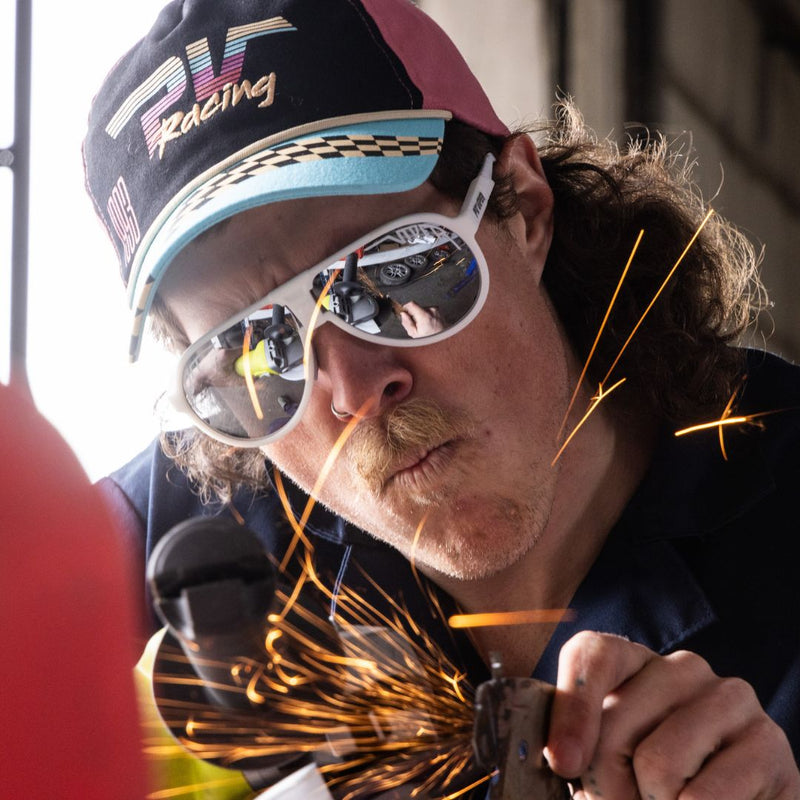/ Polarized Silver | photo_of_person.JPG | A man welds while wearing The Miami Nights Jethawk with a from Pit Viper Sunglasses