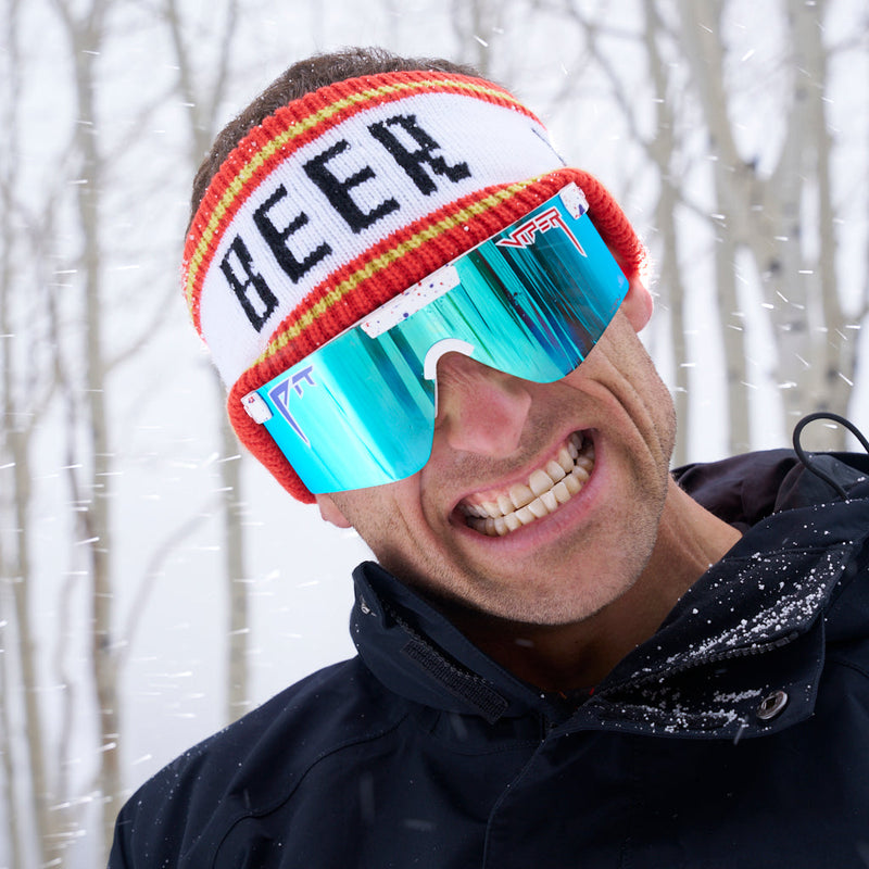  | photo_of_nick_g.JPG | Nick Goepper wearing the Beer Half Hat in a forest in the snow while smiling.