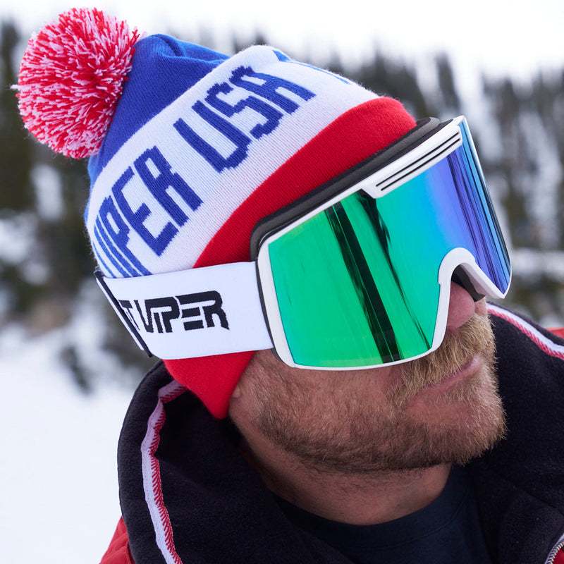 | photo_of_a_chuck.JPG | Chuck Mumford wearing the USA pom Pom Beanie with Miami Nights Backslap goggles while outside in the snow