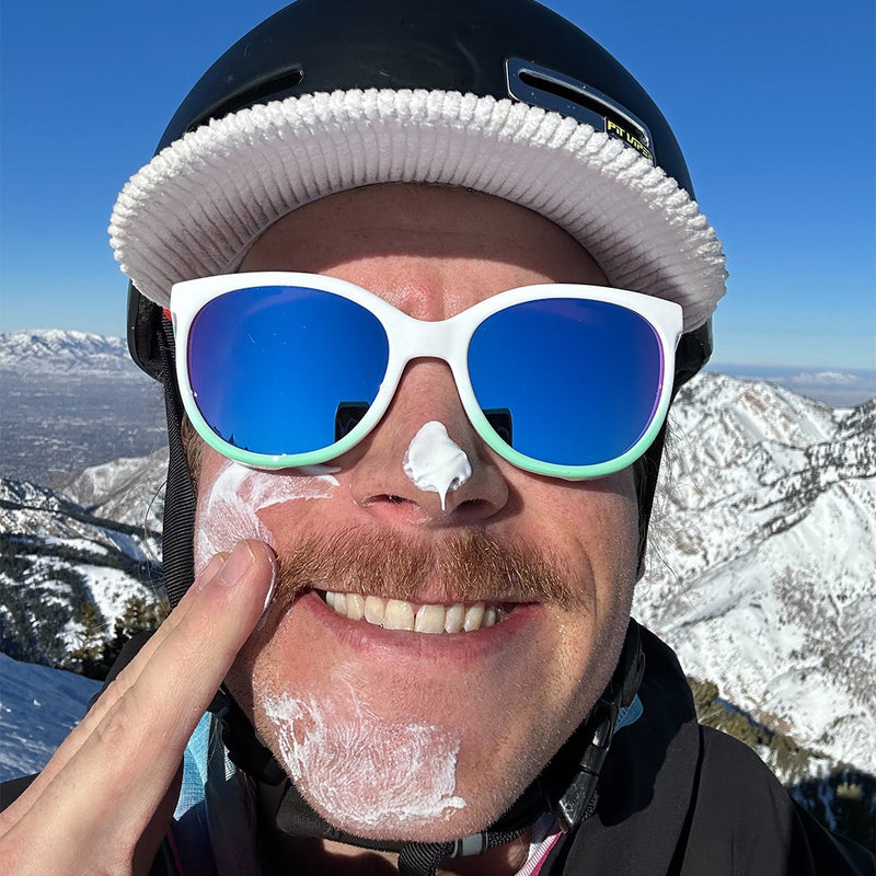  | photo_of_person.JPG | Man putting sun screen on wearing Pit Viper Sunglasses