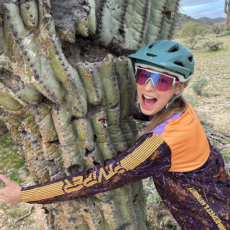 / Blue-Purple | photo_of_person_2.JPG | Woman hugging a tree wearing The Bonaire Breeze Try-Hard from Pit Viper Sunglasses