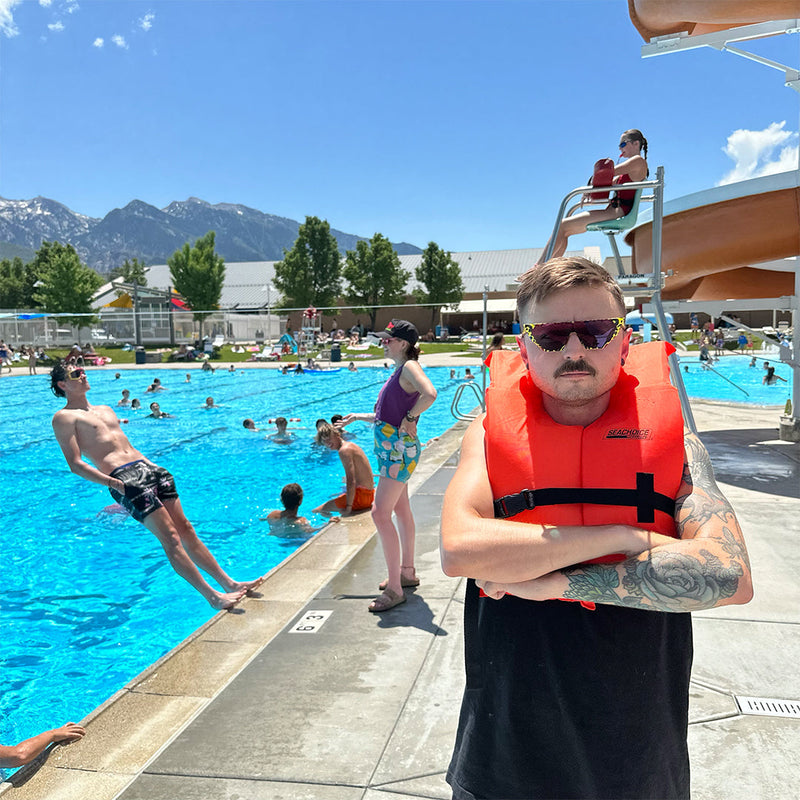  | photo_of_person_2.JPG | Man wearing a life jacket and The Carnivore Showroom from Pit Viper Sunglasses
