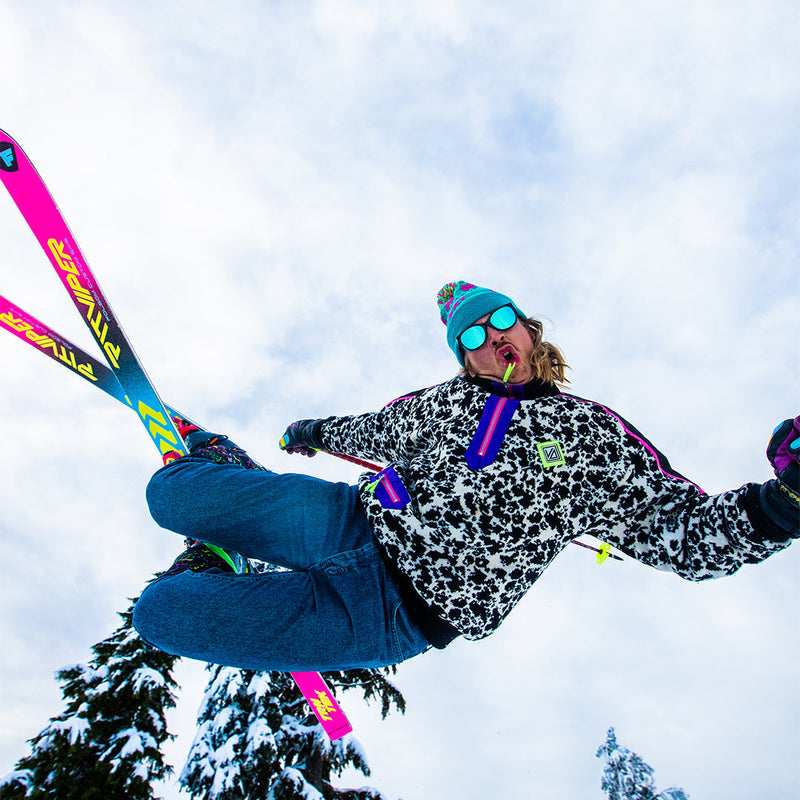 / Blue | photo_of_person.JPG | Man jumping on skis wearing Pit Viper Sunglasses