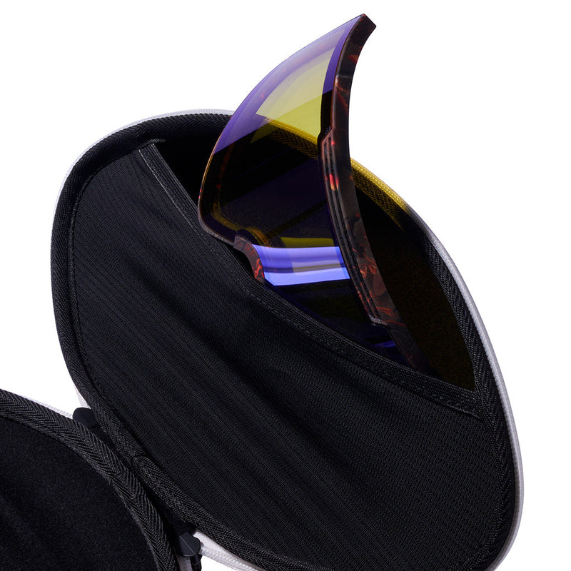 | its_a_lens_pocket.JPG | A football shaped goggle case with zippers against a white background.