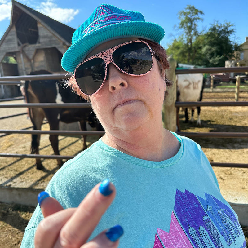 / Smoke | photo_of_person_2.JPG | A woman flipping off the camera with horses wearing Pit Viper Sunglasses